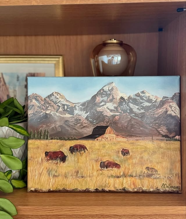 Grand Teton — bison grazing in golden fields beneath dramatic mountain range, oil on canvas by Liana De Sousa