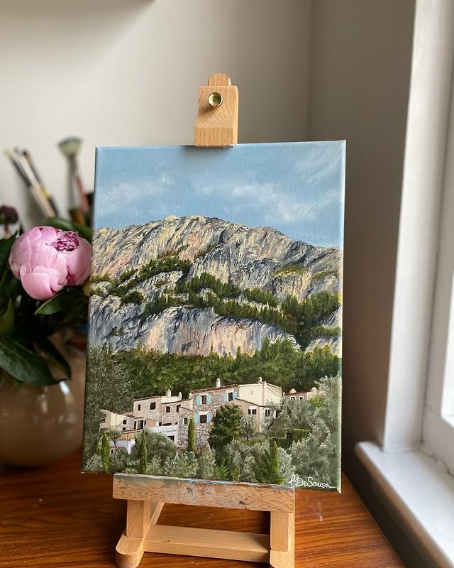 Mallorca painting on easel with flowers in background