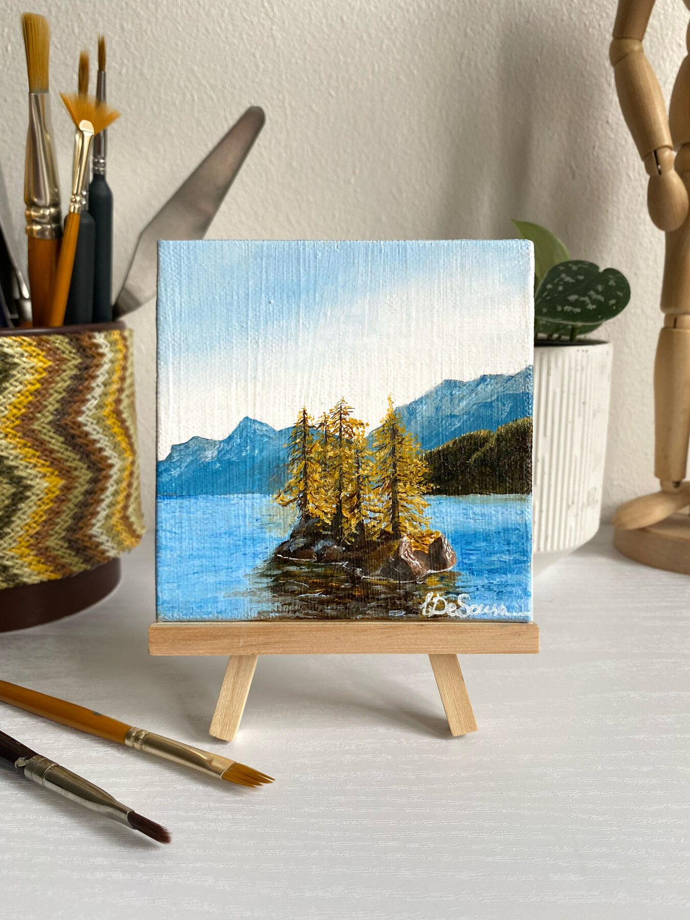 Styled desk with mini easel and painting — studio detail by Liana De Sousa